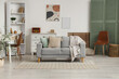 © Pixel-Shot - Interior of light living room with sofa, workplace, folding screen and shelving unit