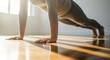 © Assetian - A person engaged in a plank exercise on a wooden floor