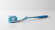 © andi - Blue and white toothbrush with toothpaste on white surface