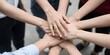 © Studicon - Diverse hands joining together to signify unity and common goals in teamwork