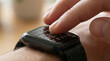 © 勇樹 島並 - Close up of a person's finger reading braille dots on a tactile smart watch screen for the visually impaired