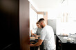 © verona_studio - Couple cooking together in kitchen, lifestyle scene