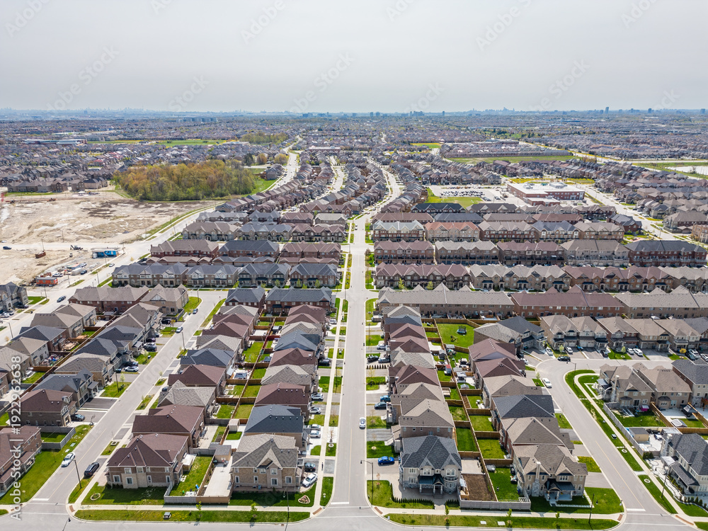 Communities Expanding Residential neighborhood expanding with new homes along winding streets ...