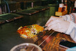 © Anna Tsukanova/Stocksy - Woman eating okonomiyaki in teppanayaki restaurant in Osaka