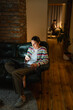 © DZ FILM/Stocksy - A woman uses a laptop and a mobile phone at home