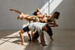 © Javier Díez/Stocksy - Contemporary dancers performing in a sunlit studio space