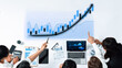 © InfiniteFlow - A business team collaborates in an office environment, analyzing financial data through charts and graphs, showcasing growth trends and effective strategies. Axiom