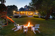© Raymond Forbes LLC/Stocksy - Backyard bonfire sunset nobody house