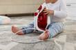 © New Africa - Child safety at home. Little boy playing with iron on floor indoors, closeup