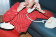 © JORGE PONZ/Stocksy - Woman enjoying popcorn while talking on a vintage phone at home