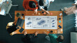© InfiniteFlow - Team members engage over vehicle design ideas and digital sketches, fostering creativity and collaboration in a modern office setting. Trope