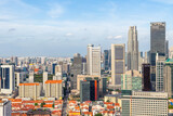 Panoramic skyline of Singapore central business district with dense modern skyscrapers and traditional red residential rooftops