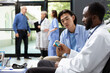 © DC Studio - African american doctor measures blood sugar levels with precision during clinic visit. Asian man receives attentive care using medical equipment, supporting diagnosis, health monitoring and treatment