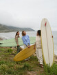 © Nicole Mason/Stocksy - Friends Enjoying Surfing by the Beach at a Coastal Location