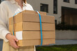 © Irina Bo/Stocksy - Delivery of multiple packages outside a modern building