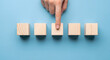 © Sakib - Choosing the right option represented by hand selecting a wooden cube block