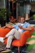 © Artem Podrez/Stocksy - Relaxed Lounge Moment with Mobile Device