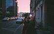 © Asya Molochkova/Stocksy - Friends Hugging and Laughing on a City Street at Dusk