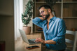 © Miljan Živković - Stressed man suffering neck pain working from home