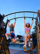 © Mal de Ojo Studio/Stocksy - Friends on Playground at Sunset