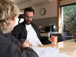 © Rowena Naylor/Stocksy - Care worker assisting client with NDIS application
