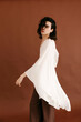 © Tania Cervian/Stocksy - Queer man posing in white flowy fashion top