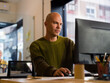 © Milles Team/Stocksy - Focused Man Working at a Desk in a Bright Office Space