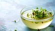 © Anggi - Close-up view of glass bowl filled with clear broth garnished with fresh microgreens highlighting clean presentation and natural ingredient freshness