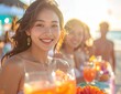 © Eti - Smiling Asian woman enjoying a vibrant beach party with friends at sunset.