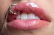 © Volodymyr - Piercing lips macro beauty detail. Piercing lips silver jewelry closeup. Piercing lips fashion style accent. Piercing lips sensual aesthetic focus.