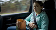 © BornHappy - A young girl feeling nauseous and dizzy while sitting in a car seat