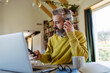© Halfpoint - Bearded man listening to music while working from homeoffice.
