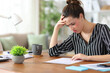 © Antonioguillem - Worried freelance worker reading contract working at home