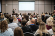 © Anton Gvozdikov - Crowd listening to business presentation, focused audience in modern conference room, professional meeting atmosphere, networking energy.