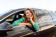 © maxbelchenko - Cheerful woman leans out window, enjoying rural landscape on sunny day. Young traveler in bright dress and hat feels free, catching wind in hair from car window. Concept: transportation, adventure.