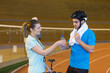 © auremar - young professional cyclist drinking water in a velodrome