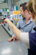 © auremar - shop assistant pointing customer to goods he needs