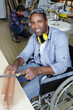 © auremar - disabled male carpenter in woodworking workshop