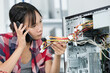 © auremar - woman on the phone fixing a pc