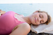 © auremar - relaxing woman sleeping on outdoors by the sea