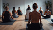 © Marvel’s Nook - Yoga class with group meditation in modern studio interior, mindfulness, breathing exercises, concept for stress relief, mental health awareness and corporate wellbeing programs