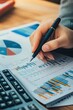 © Alexander LW - Business woman financial report calculation, cost control, budgeting with business data growth chart.