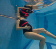 © phpetrunina14 - Pregnant woman floating underwater in swimming pool Copy Space