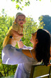 © phpetrunina14 - Mother and baby enjoying a sunny day in the park soft light
