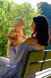 © phpetrunina14 - Mother and baby enjoying a sunny day in the park soft light