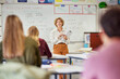 © Rido - Mature teacher explaining lesson to teenagers student