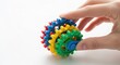 © Stock Palace - Child hand holding colorful interlocking plastic building blocks toy close-up creative play education learning fun