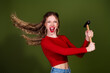© deagreez - Energetic young woman with red shirt swings an axe in a dynamic studio shot