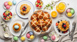 © pictureistan\ - Delicious Easter breakfast spread with pancakes, hot cross buns, and fresh fruit