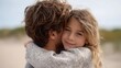 © pkproject - A father affectionately hugs his young daughter on a beach  The close up shot emphasizes their loving bond and the warm natural outdoor setting with blurred sand and sky